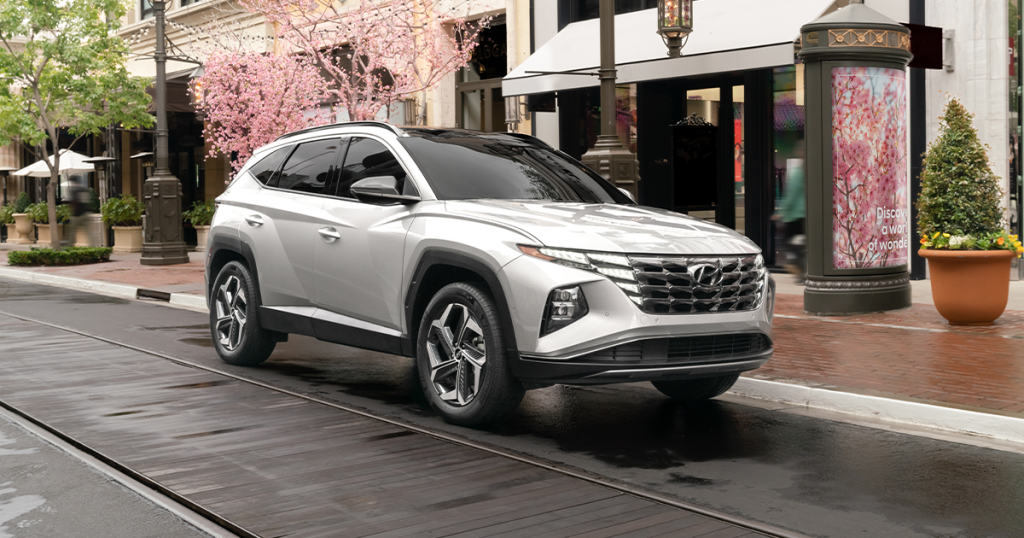 2024 Hyundai Tucson in shimmer silver parked in a city.