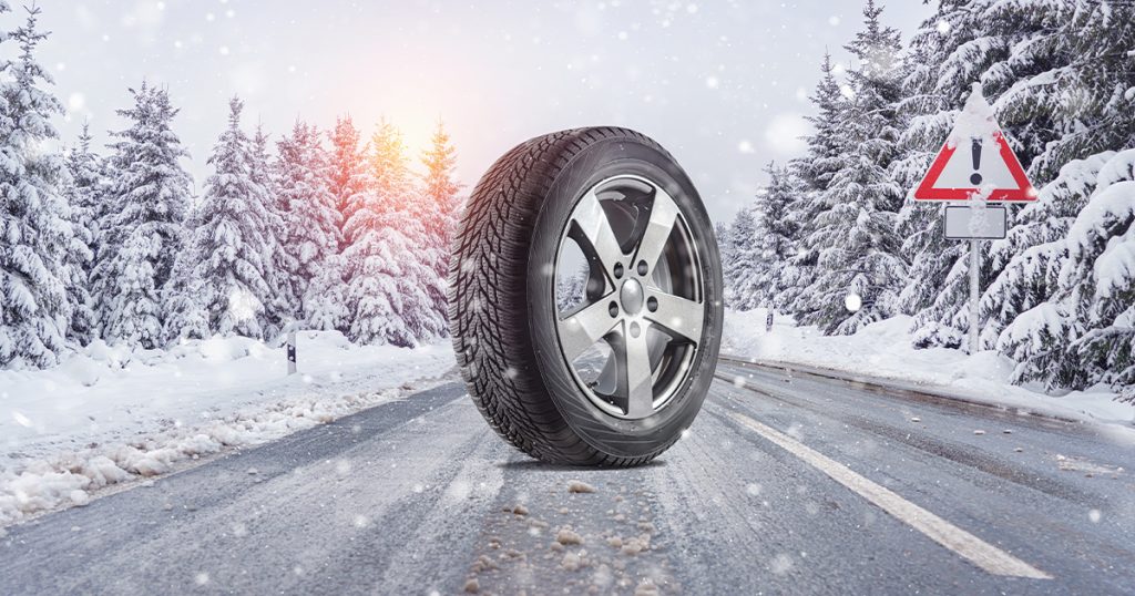 An image of a winter tire in a snowy setting.